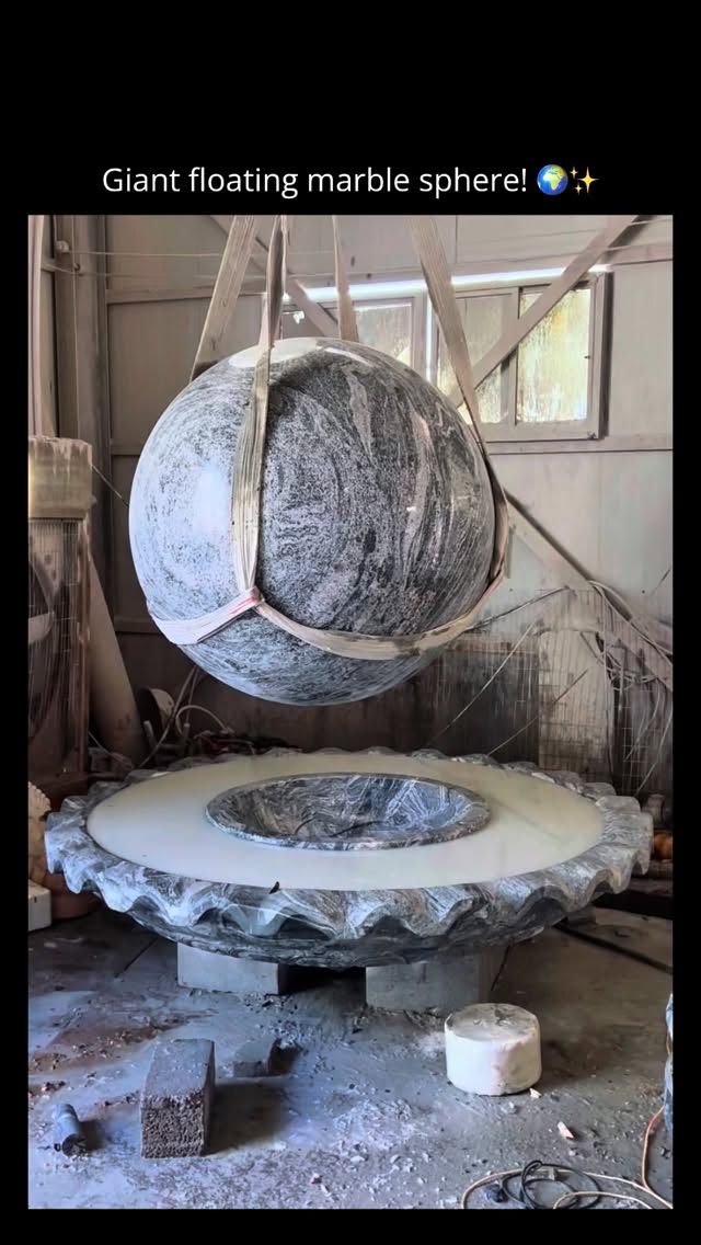 In this impressive workshop video, a massive, beautifully patterned marble sphere is being installed…